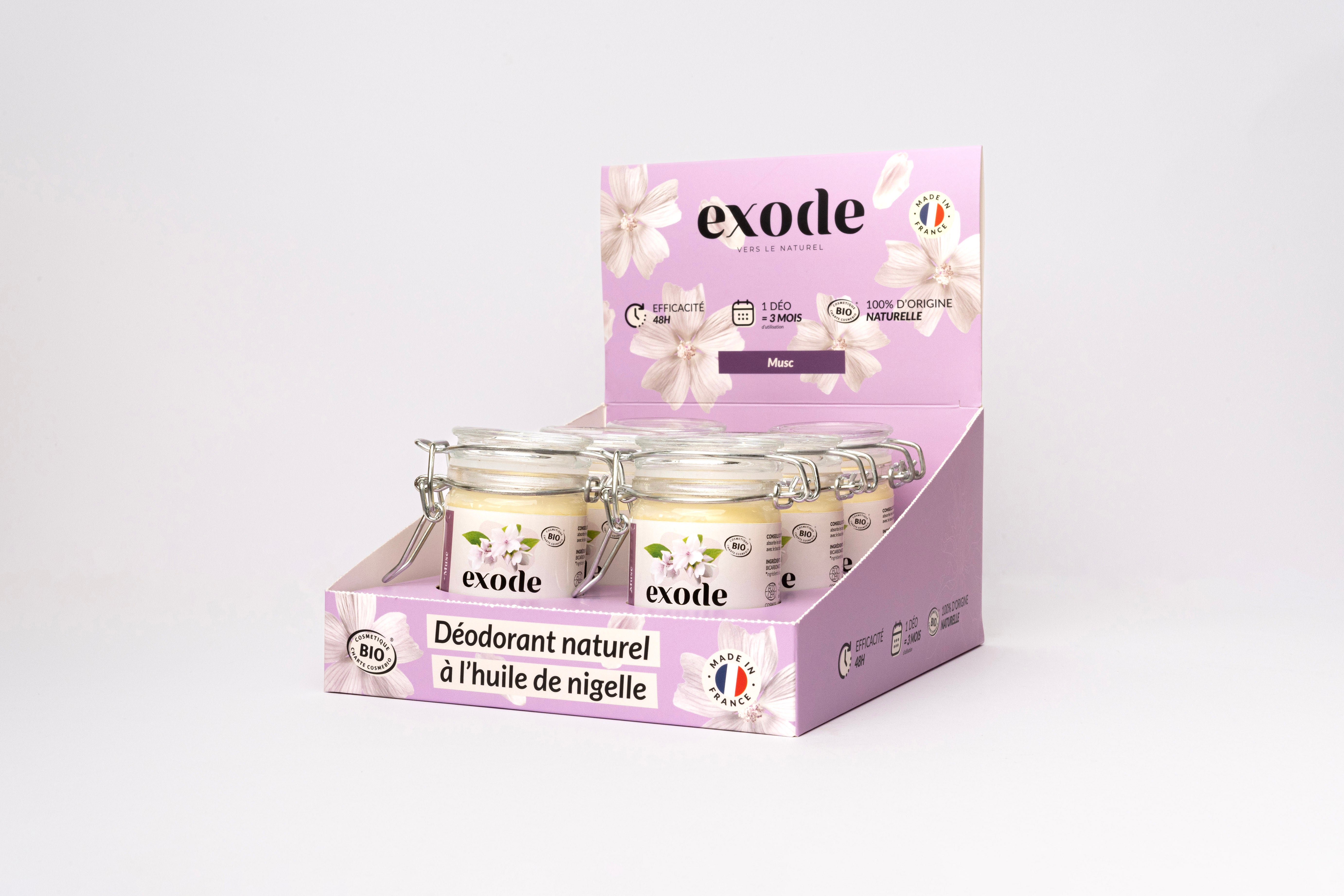 Display of 'exode' natural deodorant jars with nigella oil in a purple box.