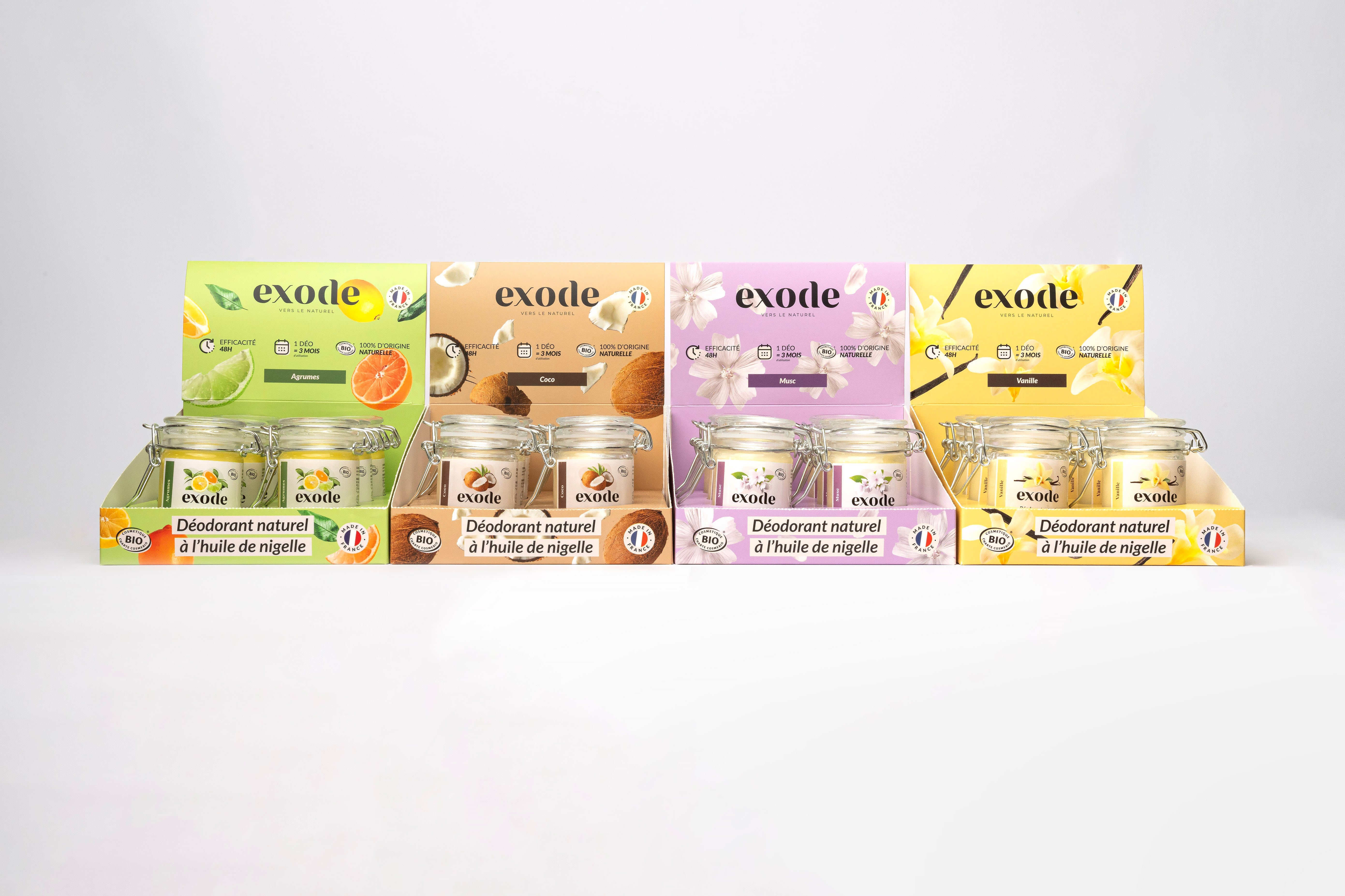 Display of Exode natural deodorant jars in various scents, including citrus, coconut, musk, and vanilla.